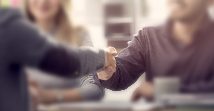 relieved man shakes hands with advisor 