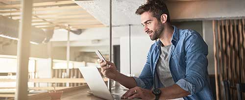 young business man on mobile and laptop